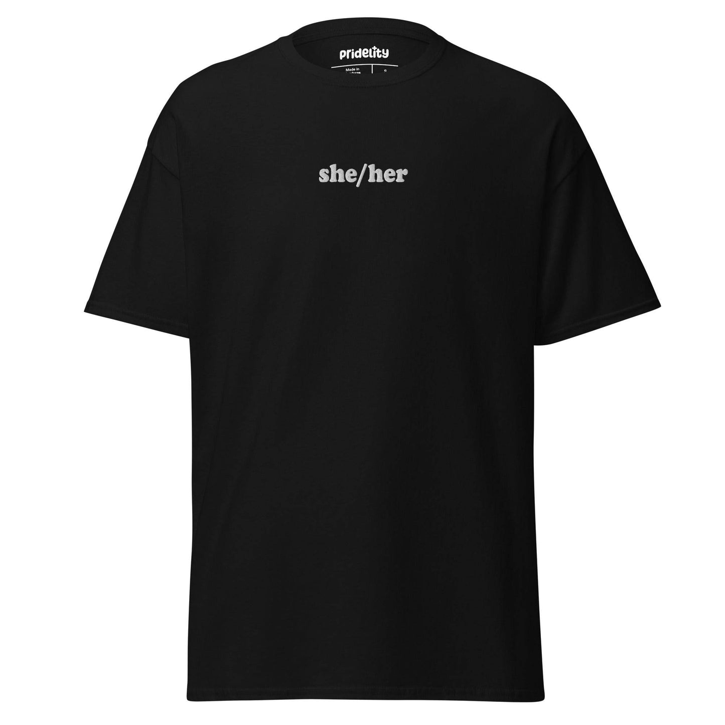 A black She/Her T-shirt by Pridelity showcases the words "she/her" in bold white text on the front, with the collar tag proudly reading "Prideify.