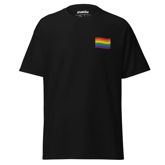 A Pride Flag T-Shirt by Pridelity in white showcases a small rainbow flag graphic on the upper left chest area, where the plain background accentuates the vibrant flag design.