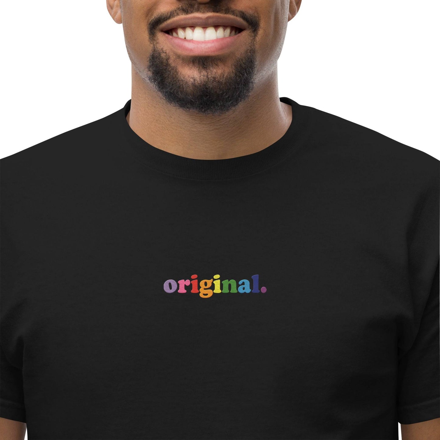 The Original T-Shirt by Pridelity is a plain white pride shirt showcasing the word "original." in lowercase multicolored text across the chest. With its short sleeves and round neckline, it stands as a statement of bold authenticity.