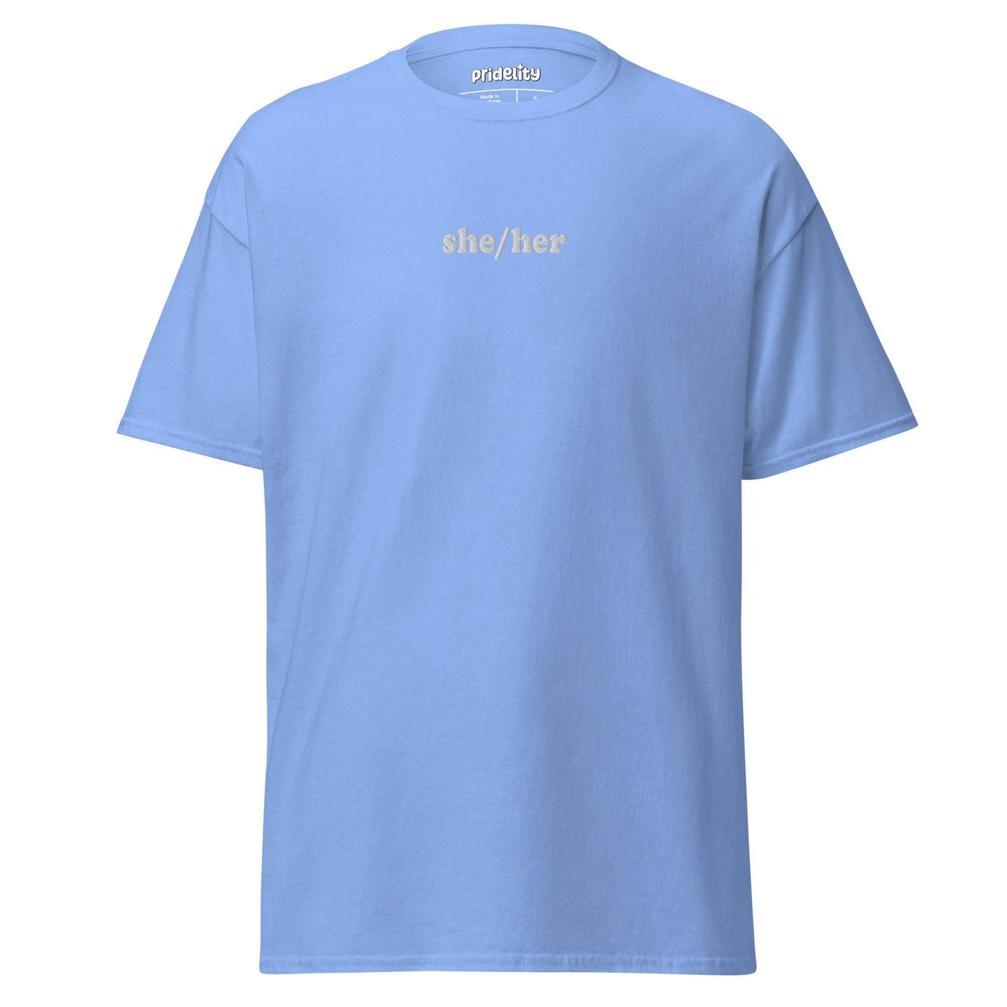 A black She/Her T-shirt by Pridelity showcases the words "she/her" in bold white text on the front, with the collar tag proudly reading "Prideify.