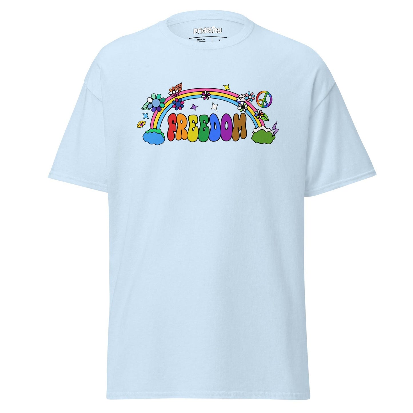 The Freedom T-Shirt by Pridelity features a colorful, cartoon-style design with "FREEDOM" in vibrant letters. A rainbow arches above clouds, flowers, and stars on the beige fabric, creating a whimsical and cheerful piece of pride merchandise.