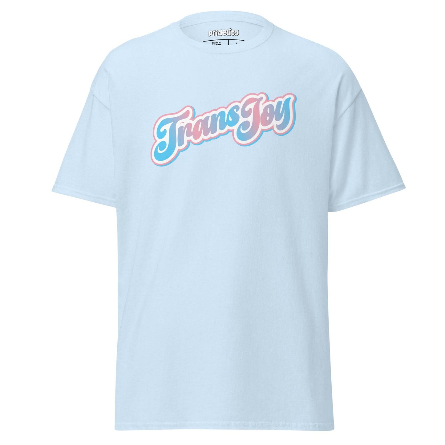 A light blue Pridelity T-shirt, named the Trans Joy T-Shirt, showcases the phrase "Trans Joy" in a stylized pink and white font across the chest.