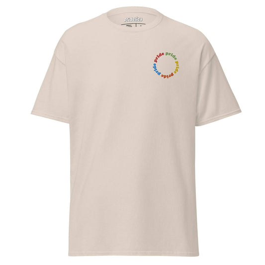 The Pride Circle T-Shirt by Pridelity showcases a beige shirt adorned with a vibrant "pride" text design arranged in a circular pattern on the upper left.