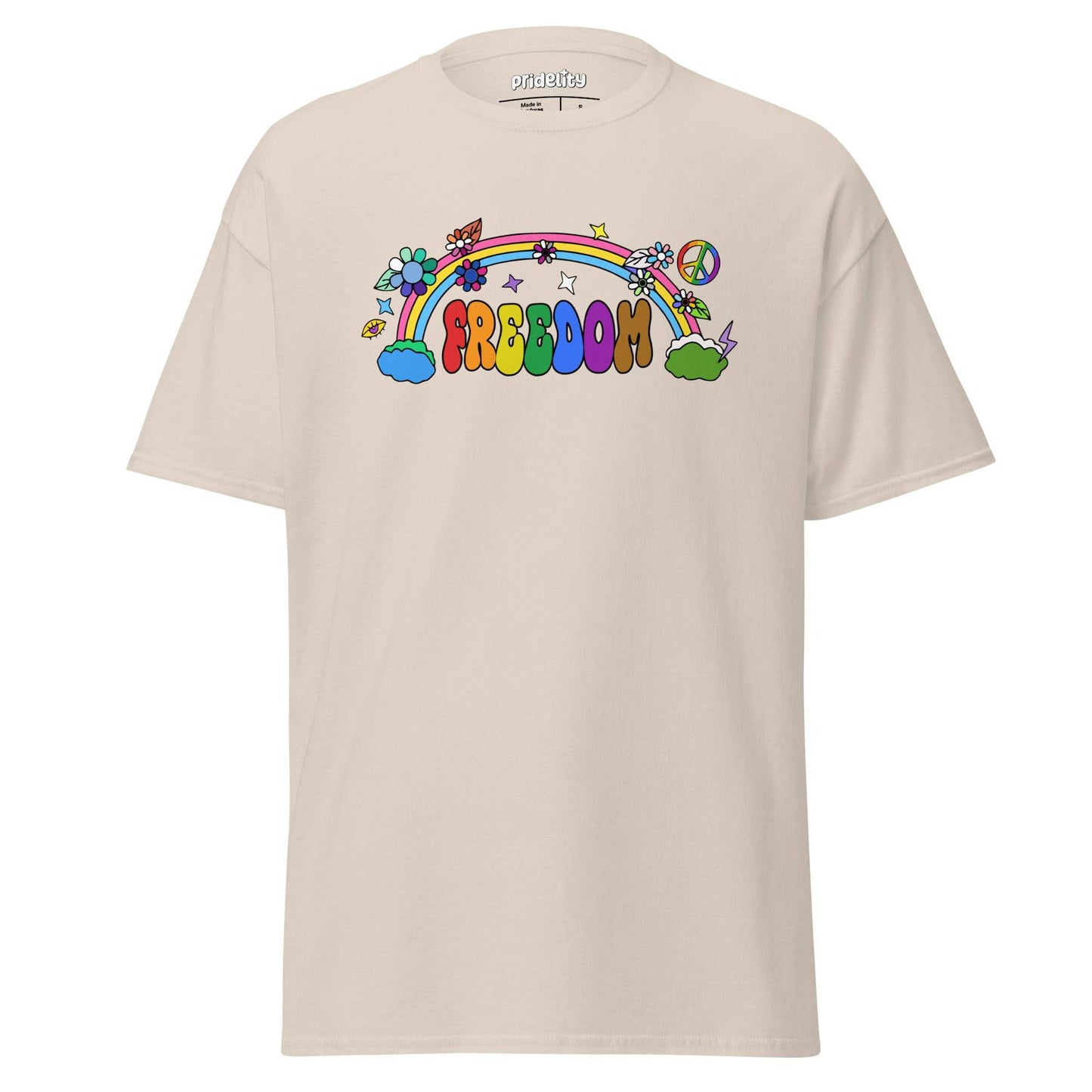 The Freedom T-Shirt by Pridelity features a colorful, cartoon-style design with "FREEDOM" in vibrant letters. A rainbow arches above clouds, flowers, and stars on the beige fabric, creating a whimsical and cheerful piece of pride merchandise.