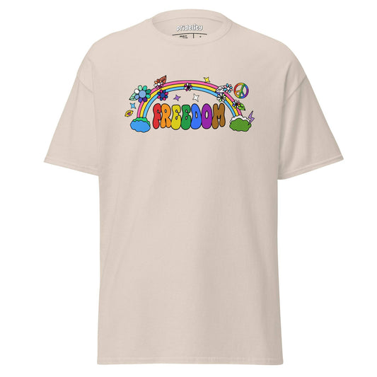 The Freedom T-Shirt by Pridelity features a colorful, cartoon-style design with "FREEDOM" in vibrant letters. A rainbow arches above clouds, flowers, and stars on the beige fabric, creating a whimsical and cheerful piece of pride merchandise.
