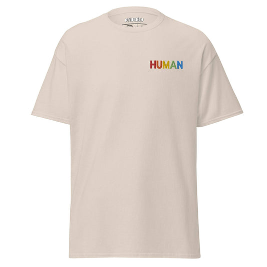 A natural-colored Pridelity Human T-Shirt, adorned with the word "HUMAN" beautifully printed in vibrant rainbow colors on the upper left side.