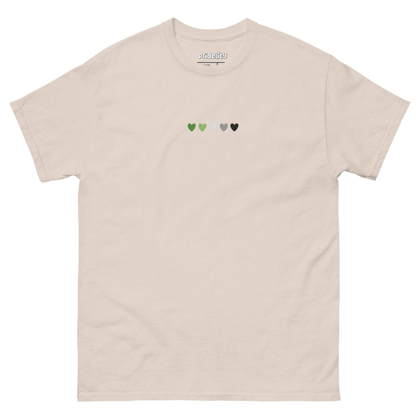 The Aromantic Love T-Shirt by Pridelity is cream-colored and features a row of small hearts across the chest in green, light green, white, gray, and black.