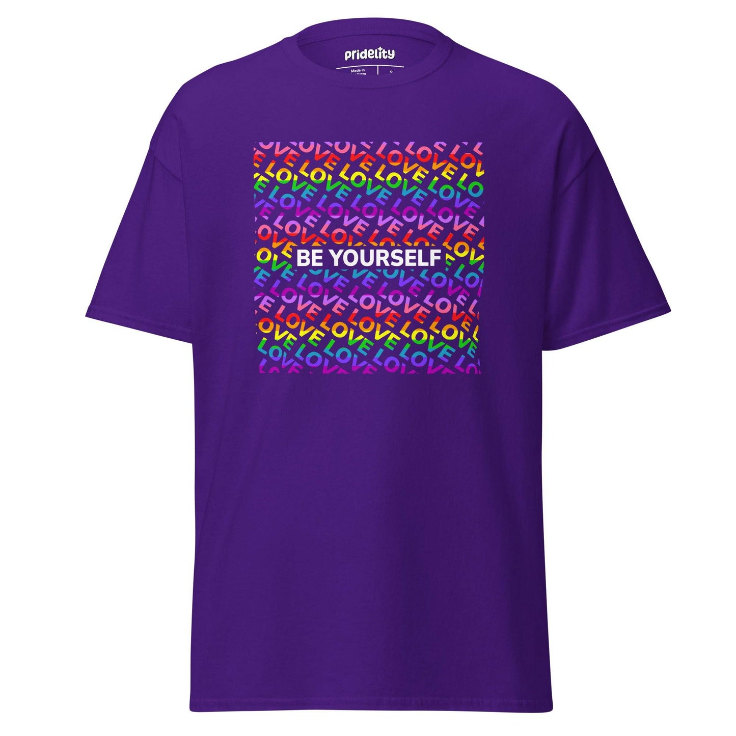 The Be Yourself T-Shirt by Pridelity features a vibrant square design with the word "LOVE" repeated in a rainbow pattern. At the center, the words "BE YOURSELF" stand out in bold white, celebrating pride and individuality.