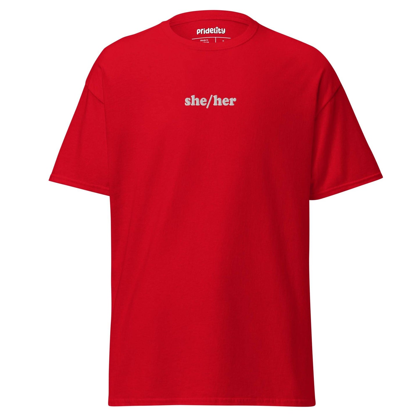 A black She/Her T-shirt by Pridelity showcases the words "she/her" in bold white text on the front, with the collar tag proudly reading "Prideify.