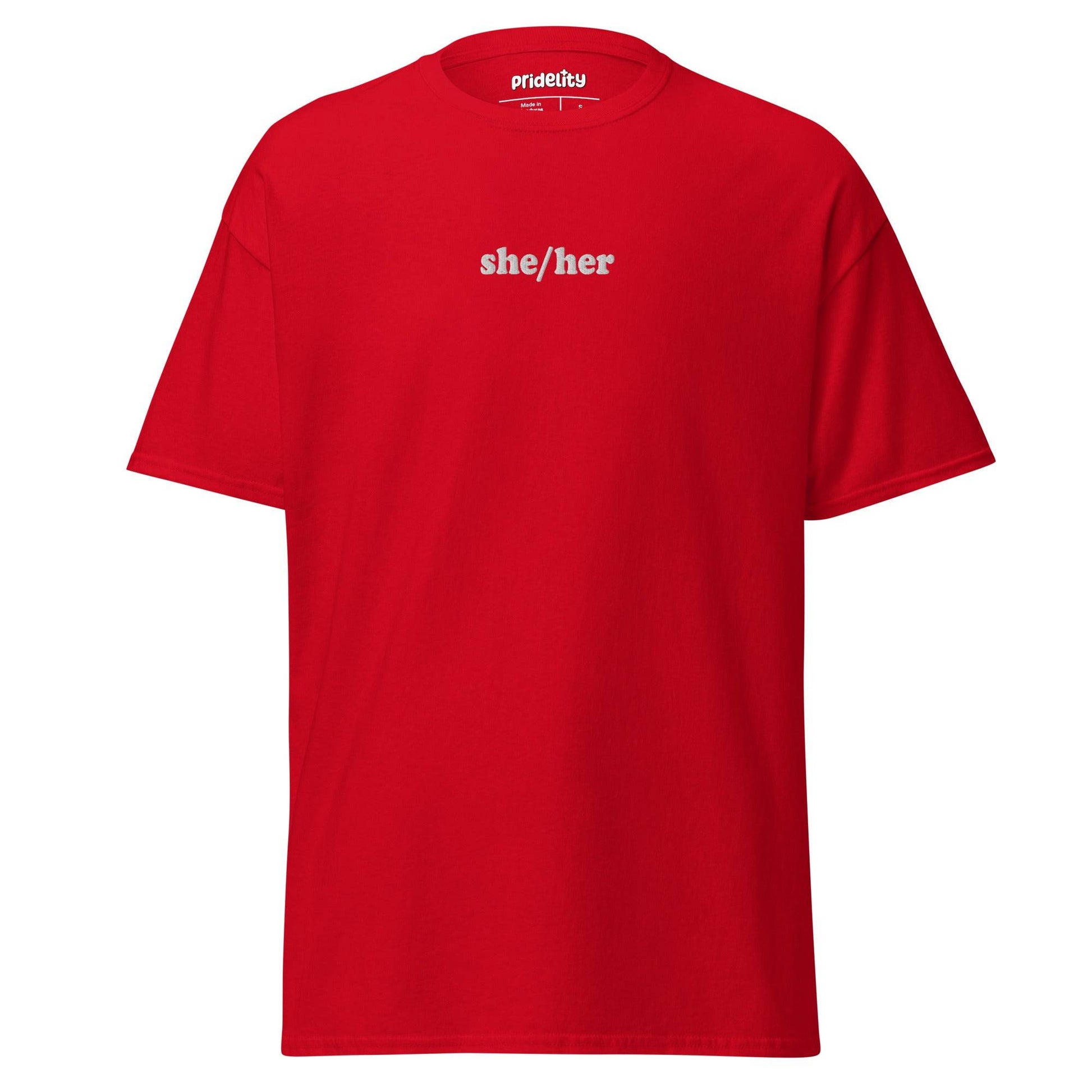 A black She/Her T-shirt by Pridelity showcases the words "she/her" in bold white text on the front, with the collar tag proudly reading "Prideify.