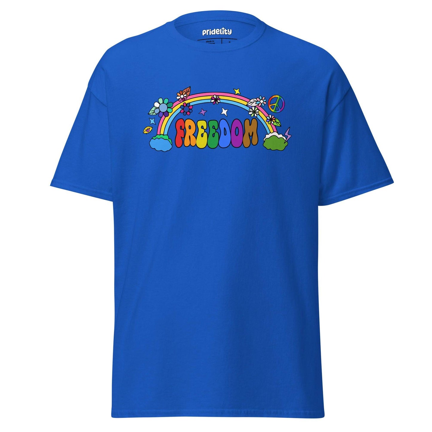 The Freedom T-Shirt by Pridelity features a colorful, cartoon-style design with "FREEDOM" in vibrant letters. A rainbow arches above clouds, flowers, and stars on the beige fabric, creating a whimsical and cheerful piece of pride merchandise.