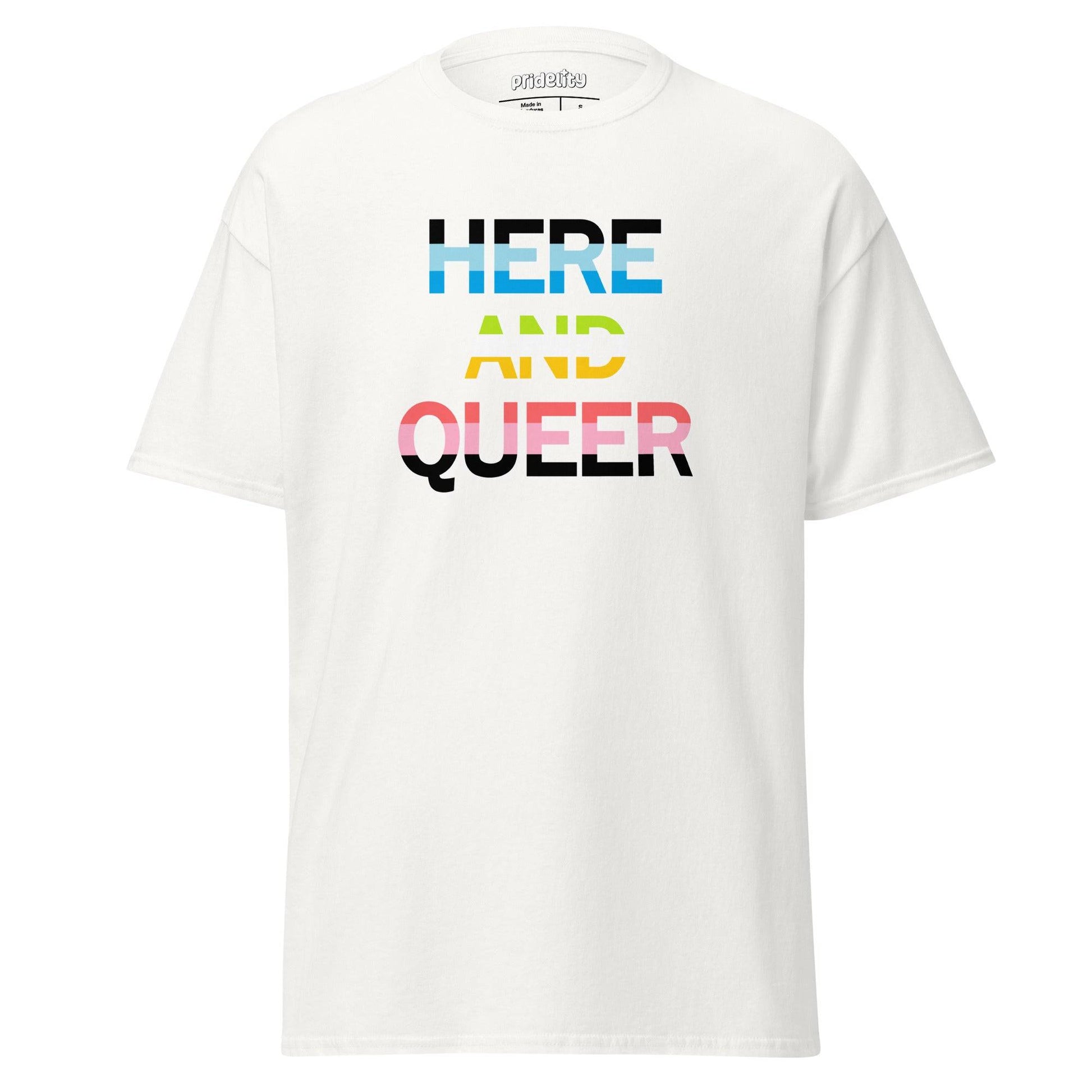 The Pridelity "Here And Queer" T-shirt showcases bold, block letters filled with the vibrant light blue, pink, and white of the transgender pride flag against a classic black background. Make a statement with this eye-catching item from our pride collection.