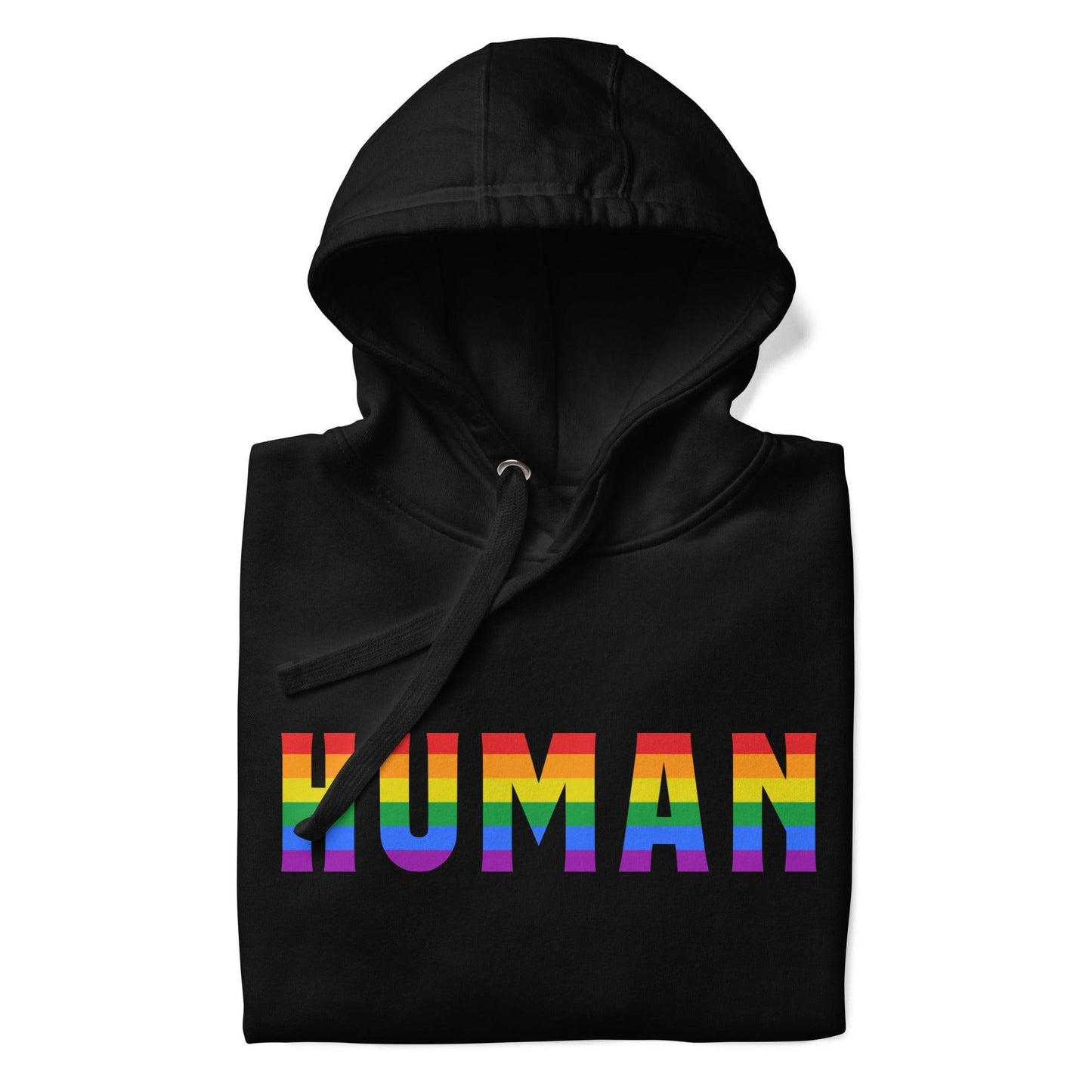 A folded Human Hoodie by Pridelity, featuring the word "HUMAN" prominently displayed in bold, rainbow-colored letters on the front. The black pride hoodie has its hood up, with untied drawstrings resting on the fabric.