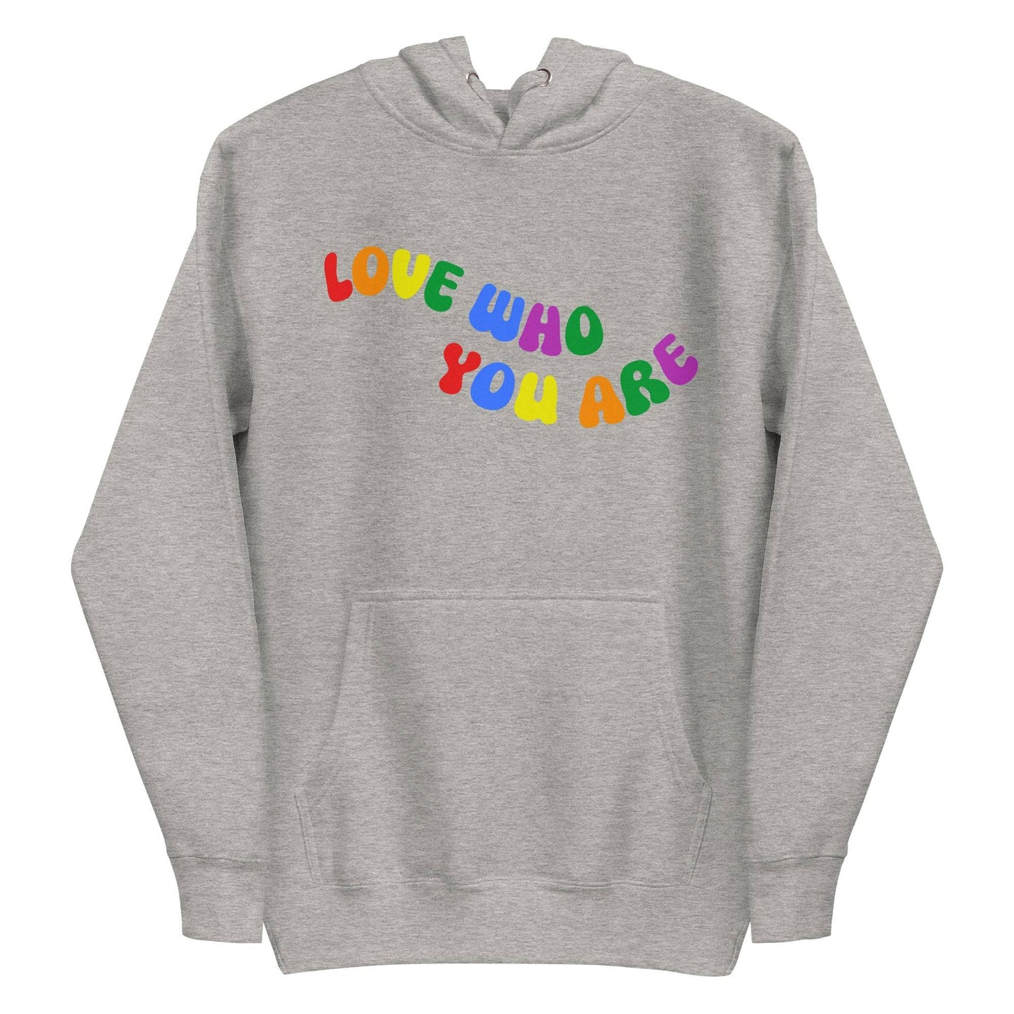 A folded Pridelity Love Who You Are Hoodie in white features vibrant, rainbow-colored text that boldly showcases the message "LOVE WHO YOU ARE" across the front. This design captures the spirit of pride apparel, honoring individuality and self-love through its colorful display.