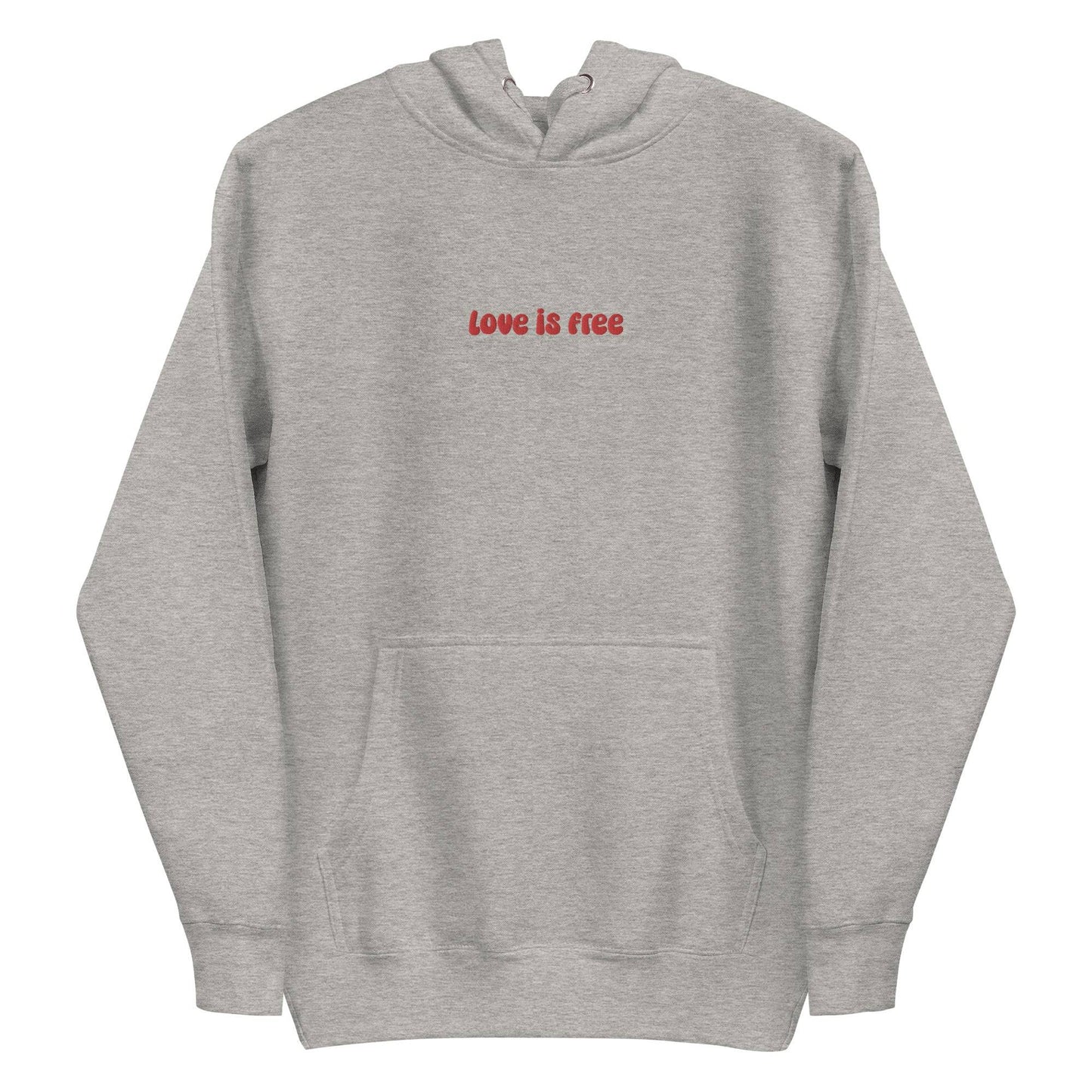 The Love Is Free Hoodie by Pridelity captures the essence of pride shirts with its folded design, featuring a hood and drawstrings, and proudly showcases the message "love is free" in red on its white front.