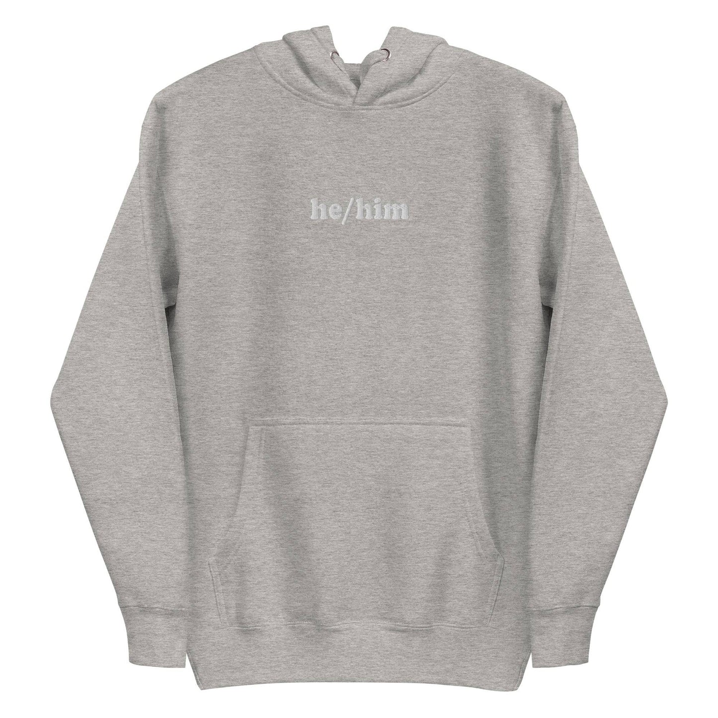 A neatly folded Pridelity He/Him Hoodie in black, featuring the text "he/him" embroidered in white on the front. The hood is showcased with its drawstrings arranged against a plain white background.