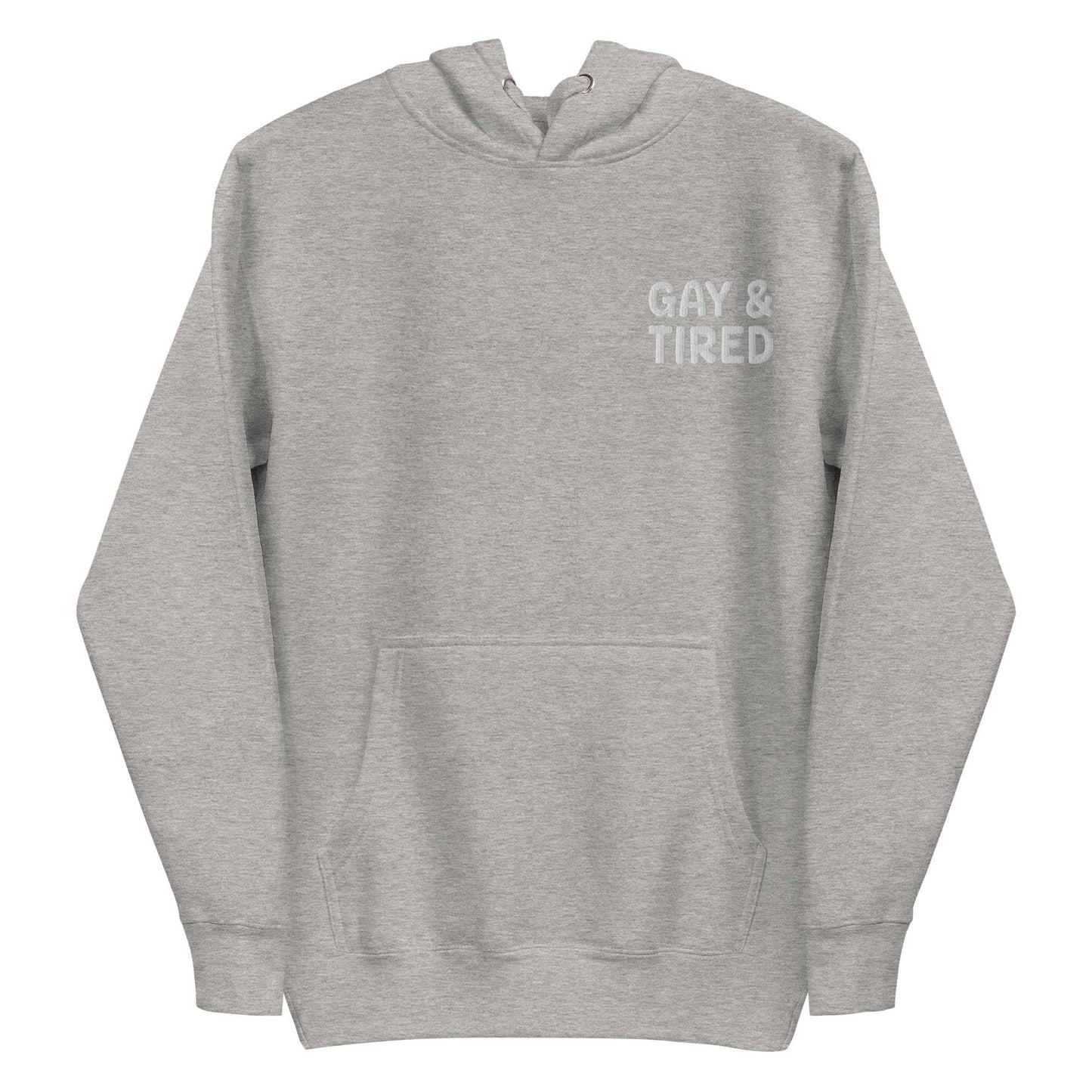 The Gay & Tired Hoodie by Pridelity is a black pride hoodie featuring white text on the upper left side that reads "GAY & TIRED." It comes with a front pocket and drawstrings for the hood.