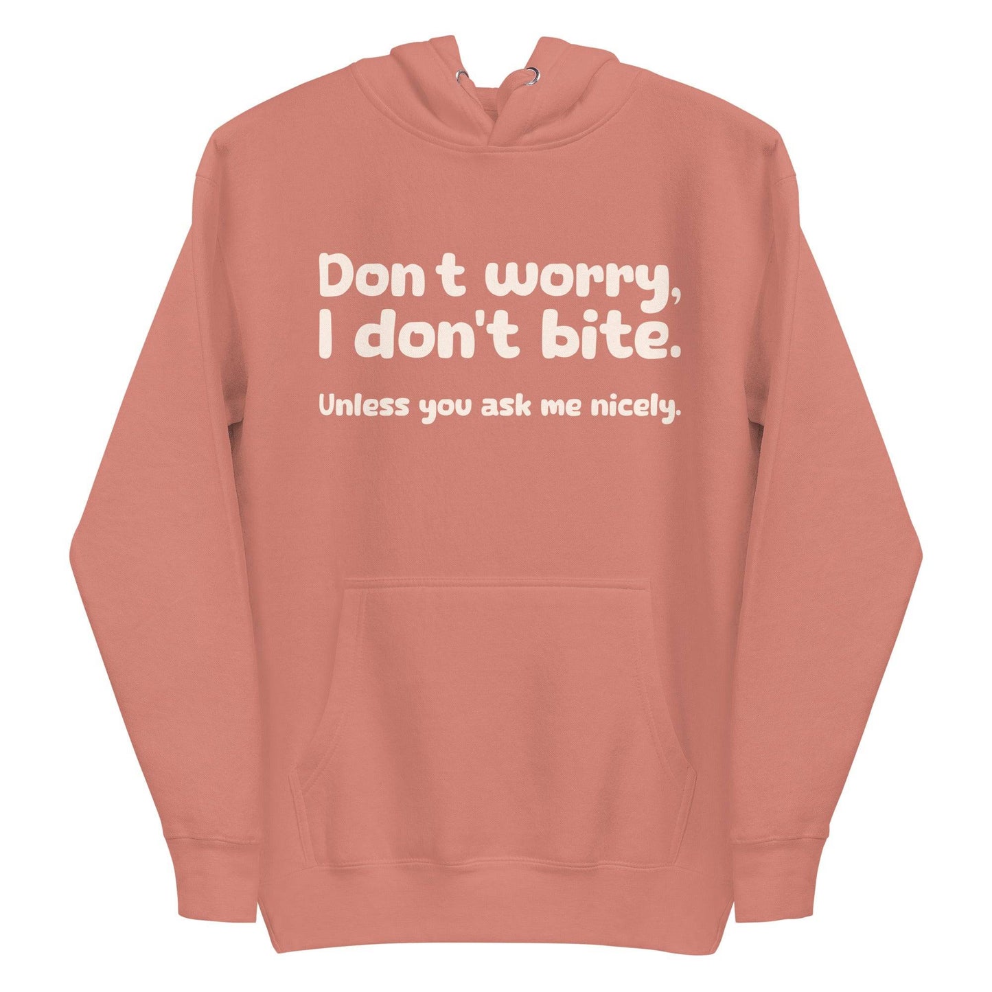 Introducing the Pridelity "I Don't Bite" Hoodie in pink, featuring bold white text on the front that reads, "Don't worry, I don't bite. Unless you ask me nicely." Perfect for those who embrace humor and identity with style.