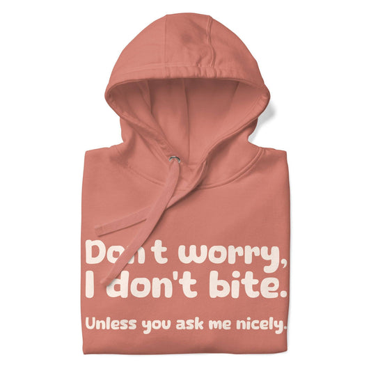 Introducing the Pridelity "I Don't Bite" Hoodie in pink, featuring bold white text on the front that reads, "Don't worry, I don't bite. Unless you ask me nicely." Perfect for those who embrace humor and identity with style.
