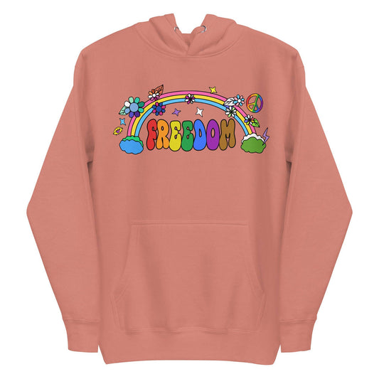 A folded dusty rose Freedom Hoodie from Pridelity features a vibrant design with "Freedom" in rainbow letters. It's adorned with flowers, stars, a rainbow, and a peace symbol, all in a playful retro style.