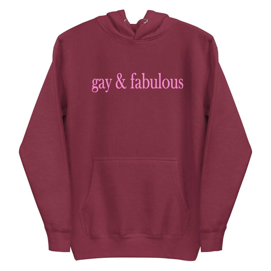 Introducing the Pridelity "Gay & Fabulous" Hoodie in maroon, featuring a front pocket and the phrase "gay & fabulous" prominently displayed in pink across the chest.