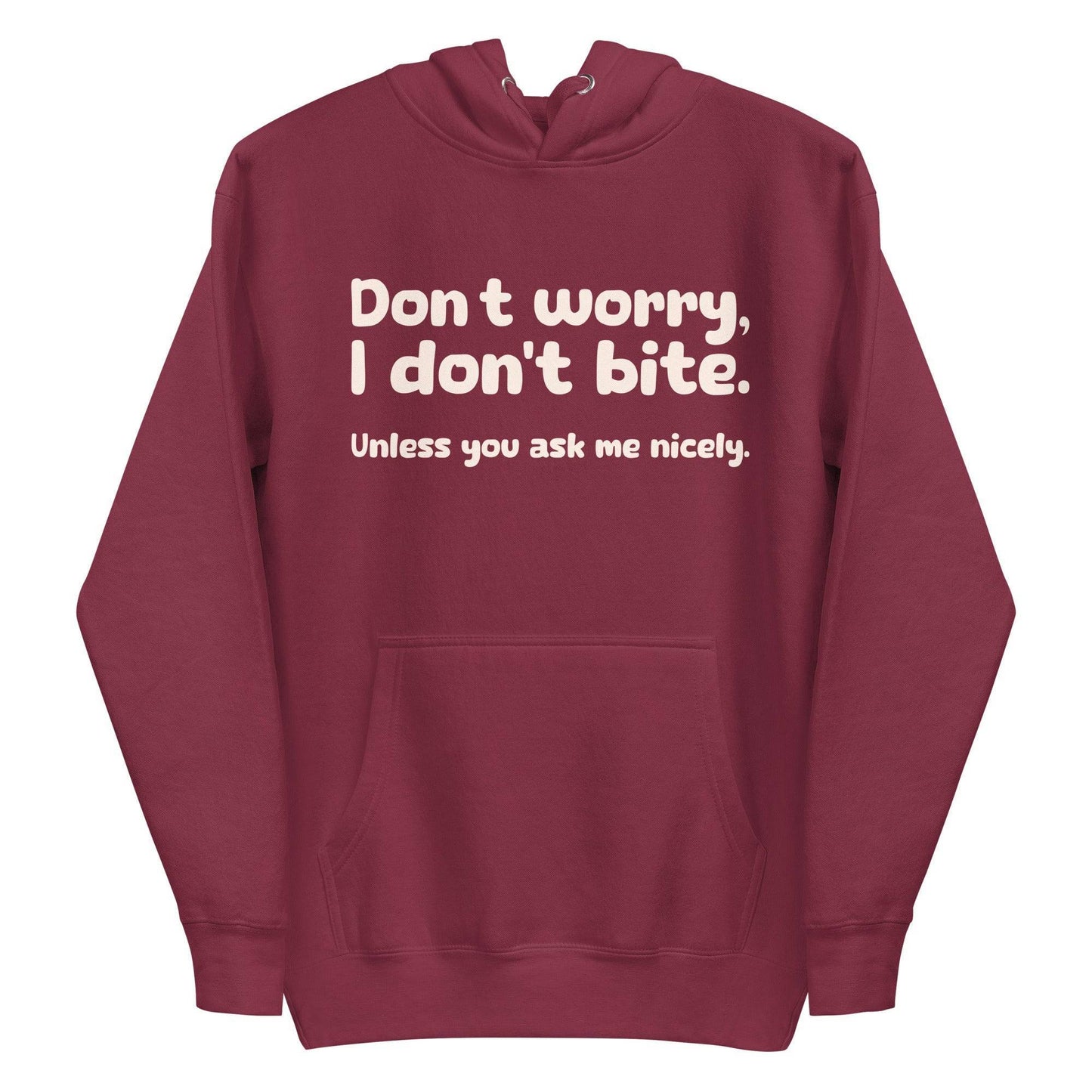 Introducing the Pridelity "I Don't Bite" Hoodie in pink, featuring bold white text on the front that reads, "Don't worry, I don't bite. Unless you ask me nicely." Perfect for those who embrace humor and identity with style.