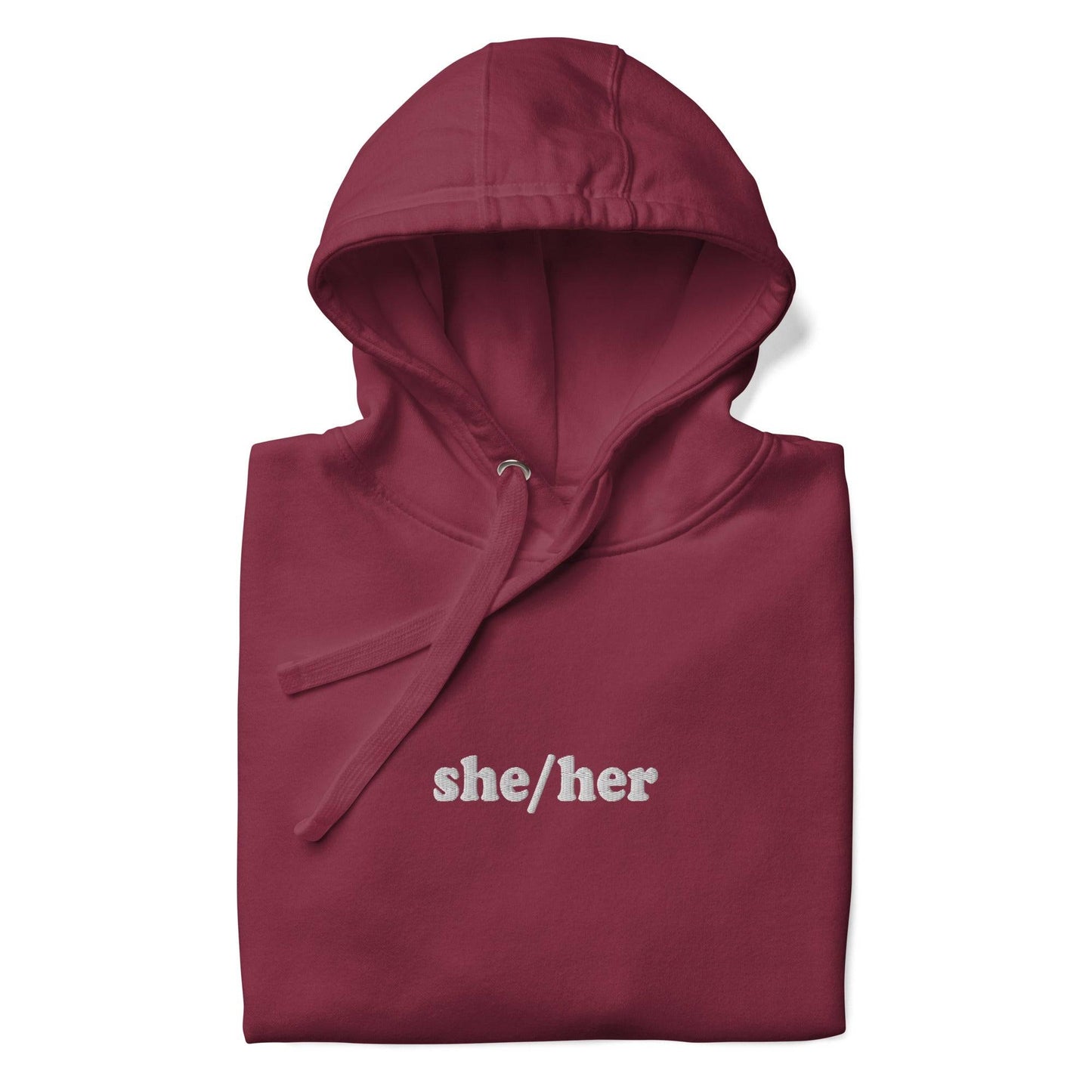 Introducing the She/Her Hoodie from Pridelity's pride collection, crafted in a maroon hue and adorned with "she/her" text in white on the chest. This hoodie features a front pocket and drawstrings at the hood, providing a straightforward and casual style ideal for promoting LGBTQ+ visibility.