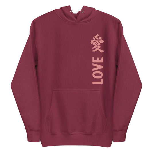 The Love Kanji Hoodie from Pridelity is a black piece featuring the word "LOVE" in pink capital letters running vertically on the front, coupled with a pink stylized Chinese character. This pride-inspired hoodie is designed with a front pocket and drawstring hood, seamlessly blending style with a bold expression of love.