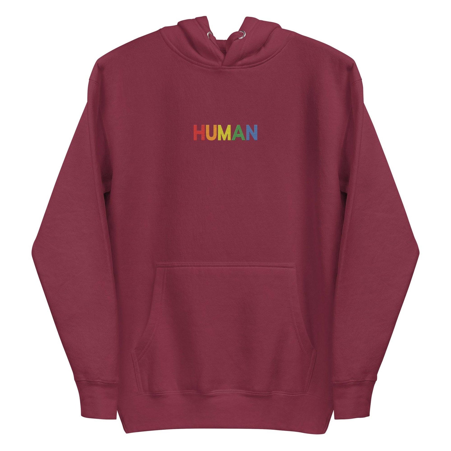 A folded Pridelity Human Hoodie, showcasing a crisp white design with "HUMAN" embroidered in vibrant rainbow colors on the front. The hood is laid flat, with its drawstrings visible, celebrating individuality and self-expression.