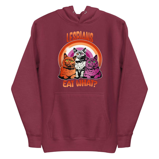 The maroon "Lesbians Eat What?" hoodie from Pridelity features three vibrant cats set against a rainbow background. The word "Lesbians" is prominently displayed above, with the humorous phrase "Eat What?" boldly written below, making it an ideal pride garment for those who want to express their style and humor.