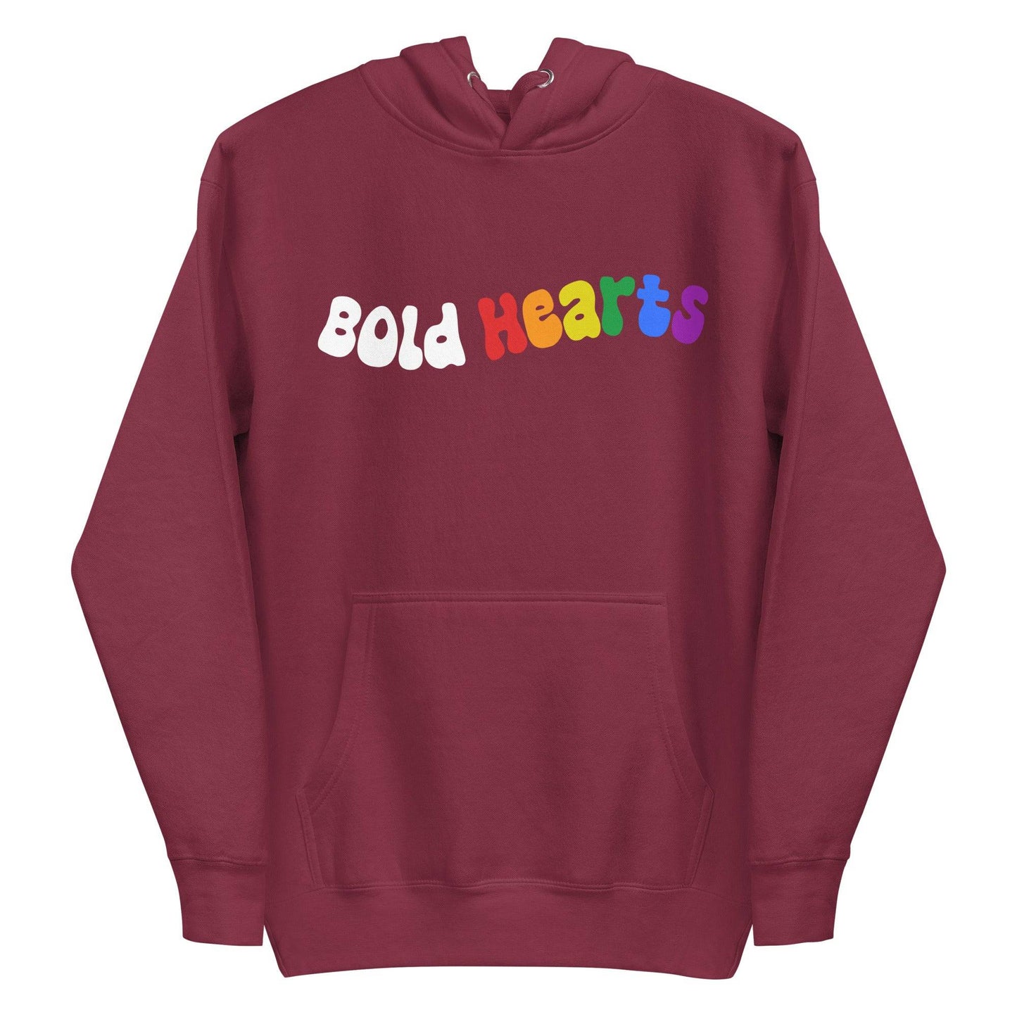 The Bold Hearts Hoodie from Pridelity is a black garment showcasing the words "Bold Hearts" on the front in a playful, wavy font to celebrate Pride. "Bold" stands out in white, while "Hearts" captivates with a vibrant rainbow gradient. This stylish piece of Pride merchandise includes a front pocket and drawstring hood for extra comfort.
