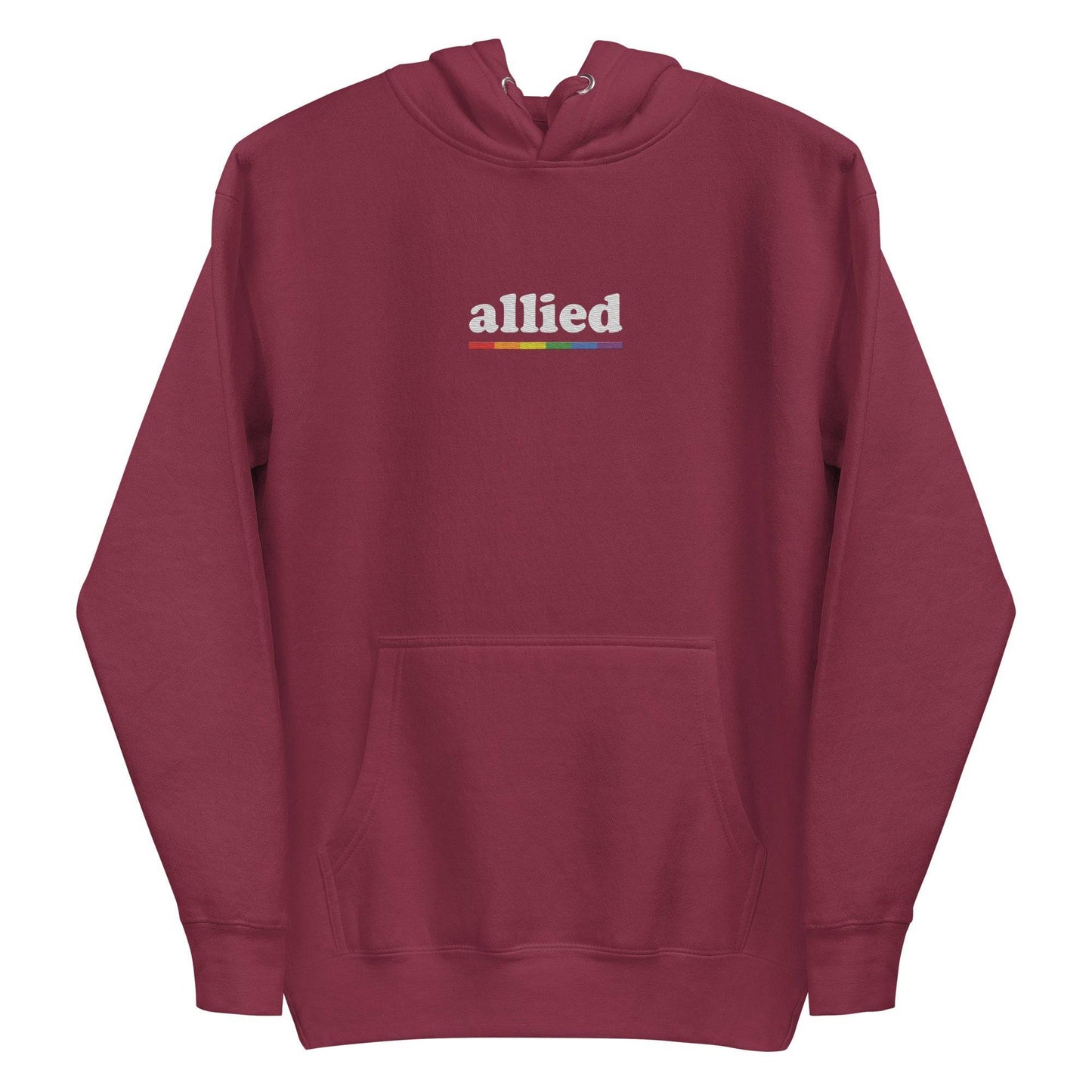 The Allied Hoodie by Pridelity is a black hoodie adorned with the word "allied" in white text across the chest, accompanied by a vibrant horizontal rainbow stripe below. This piece of Pride Merch features a front pocket and a drawstring hood, effortlessly combining comfort with meaningful expression.