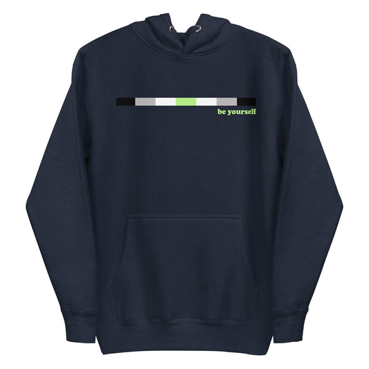 Introducing the Pridelity Agender Hoodie: a navy blue hoodie featuring a horizontal color bar in black, gray, white, and green. Adjacent to the bar on the right side is green text that reads "be yourself." This exclusive item from our Pride Collection includes a front pocket and drawstring hood.