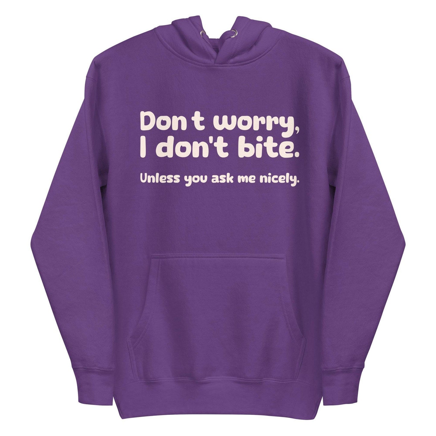 Introducing the Pridelity "I Don't Bite" Hoodie in pink, featuring bold white text on the front that reads, "Don't worry, I don't bite. Unless you ask me nicely." Perfect for those who embrace humor and identity with style.