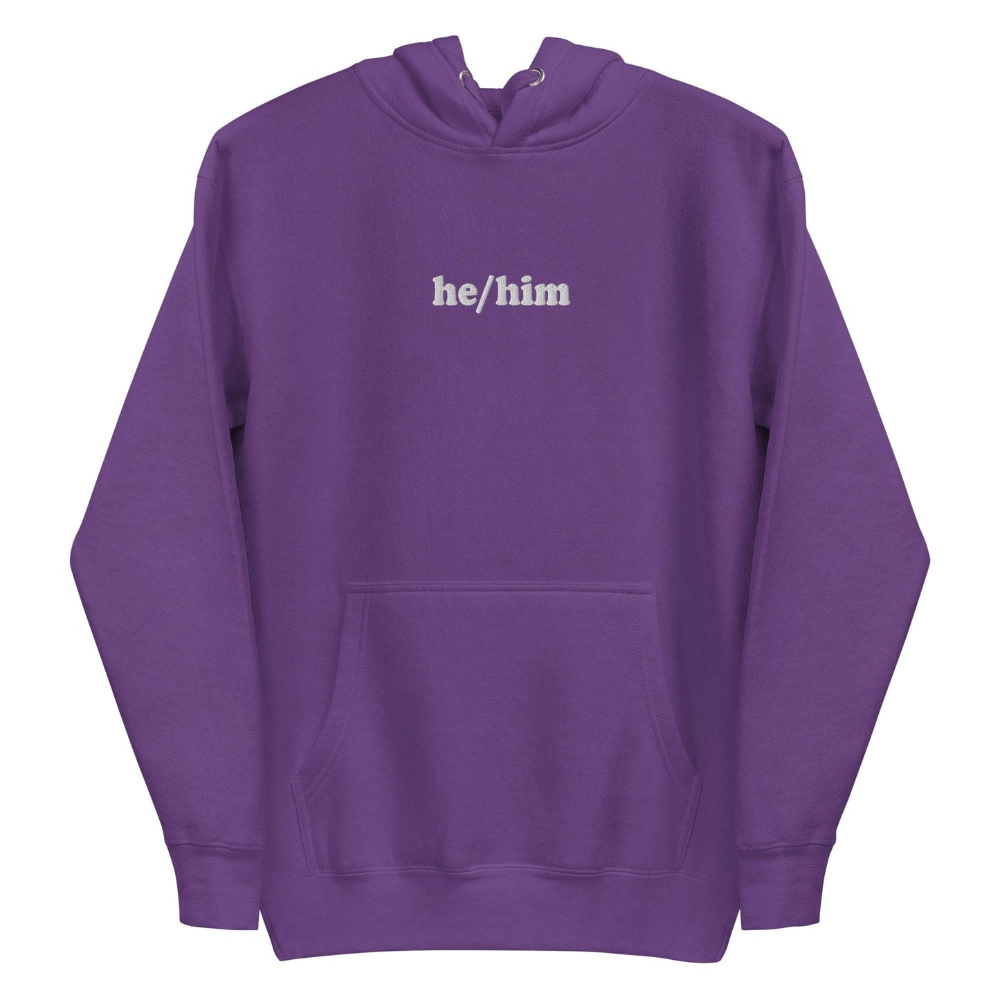 A neatly folded Pridelity He/Him Hoodie in black, featuring the text "he/him" embroidered in white on the front. The hood is showcased with its drawstrings arranged against a plain white background.