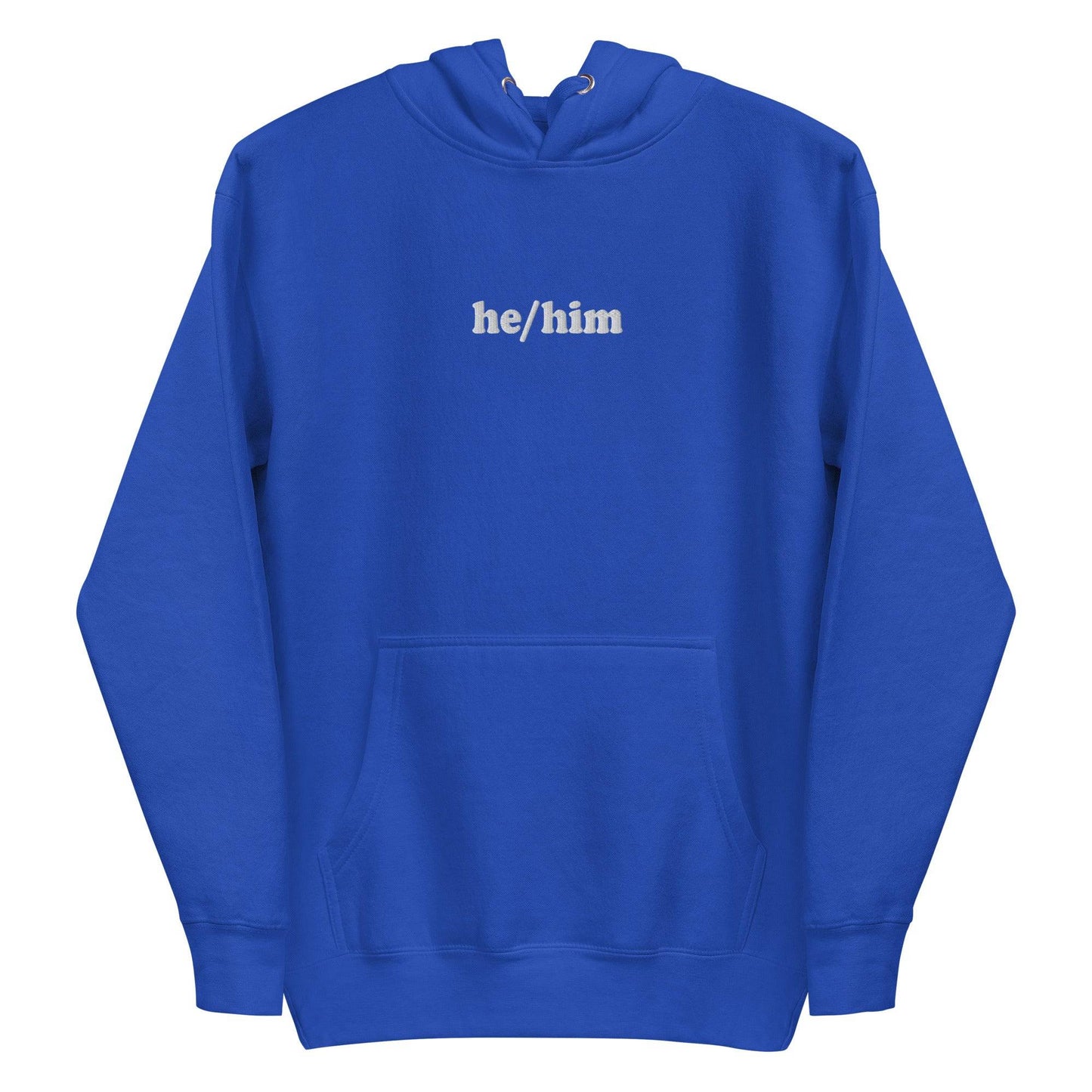 A neatly folded Pridelity He/Him Hoodie in black, featuring the text "he/him" embroidered in white on the front. The hood is showcased with its drawstrings arranged against a plain white background.