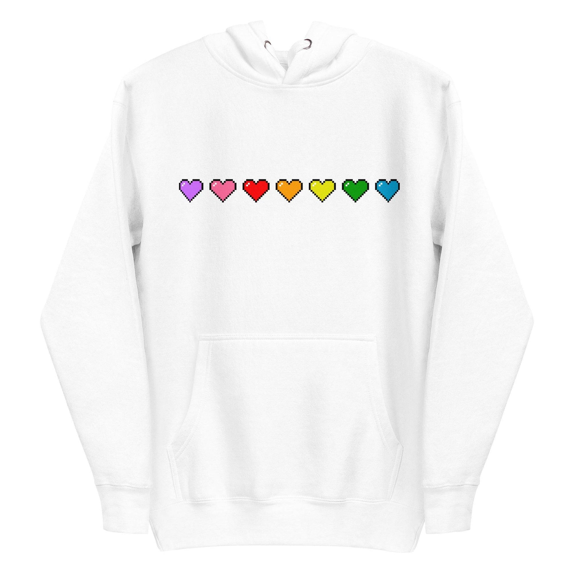 Introducing the Pixel Hearts Hoodie by Pridelity: This white hoodie showcases a row of pixelated hearts in vibrant rainbow colors—purple, pink, red, orange, yellow, green, and blue—across the chest, capturing the lively essence of pride shirts. It is designed with a convenient front pocket and a drawstring hood for added style and comfort.