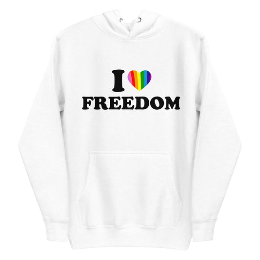 A neatly folded white "I Love Freedom Hoodie" by Pridelity showcases the phrase "I ♥ FREEDOM" accompanied by a rainbow heart, symbolizing diversity and inclusivity. The hoodie is arranged with drawstrings and the hood prominently displayed on top.