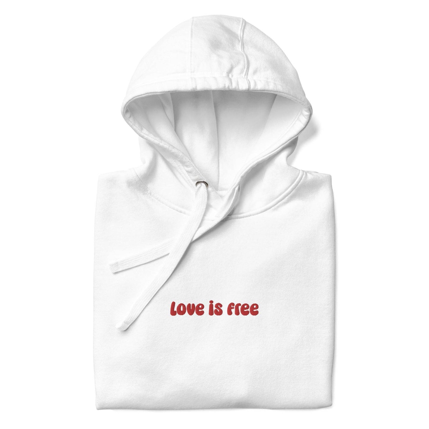 The Love Is Free Hoodie by Pridelity captures the essence of pride shirts with its folded design, featuring a hood and drawstrings, and proudly showcases the message "love is free" in red on its white front.