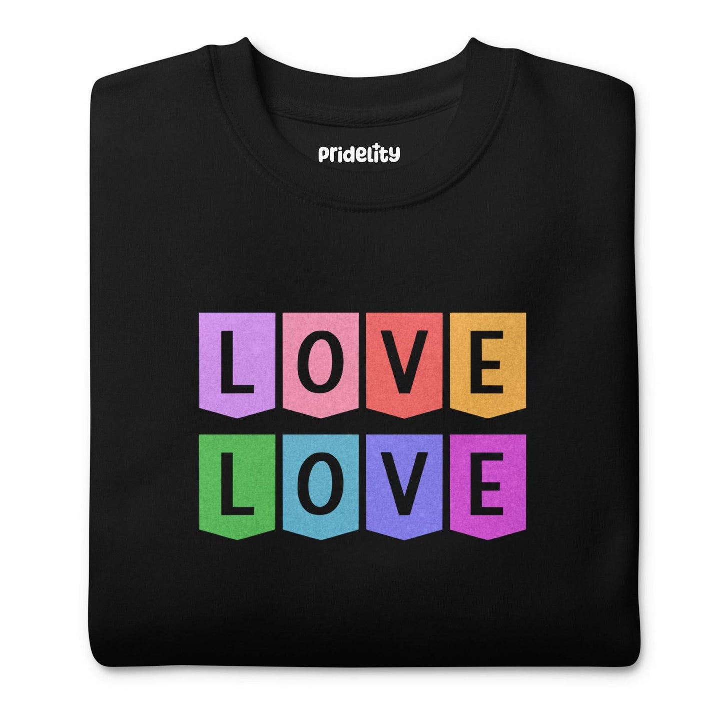 Introducing the Pridelity "Love Love Sweatshirt," a chic black sweatshirt showcasing the word "LOVE" repeated twice in a vivid rainbow block design, featuring bold letters in pink, yellow, purple, orange, and green. The playful and vibrant arrangement of the letters in two rows makes it an ideal choice for those who have a flair for rainbow fashion.