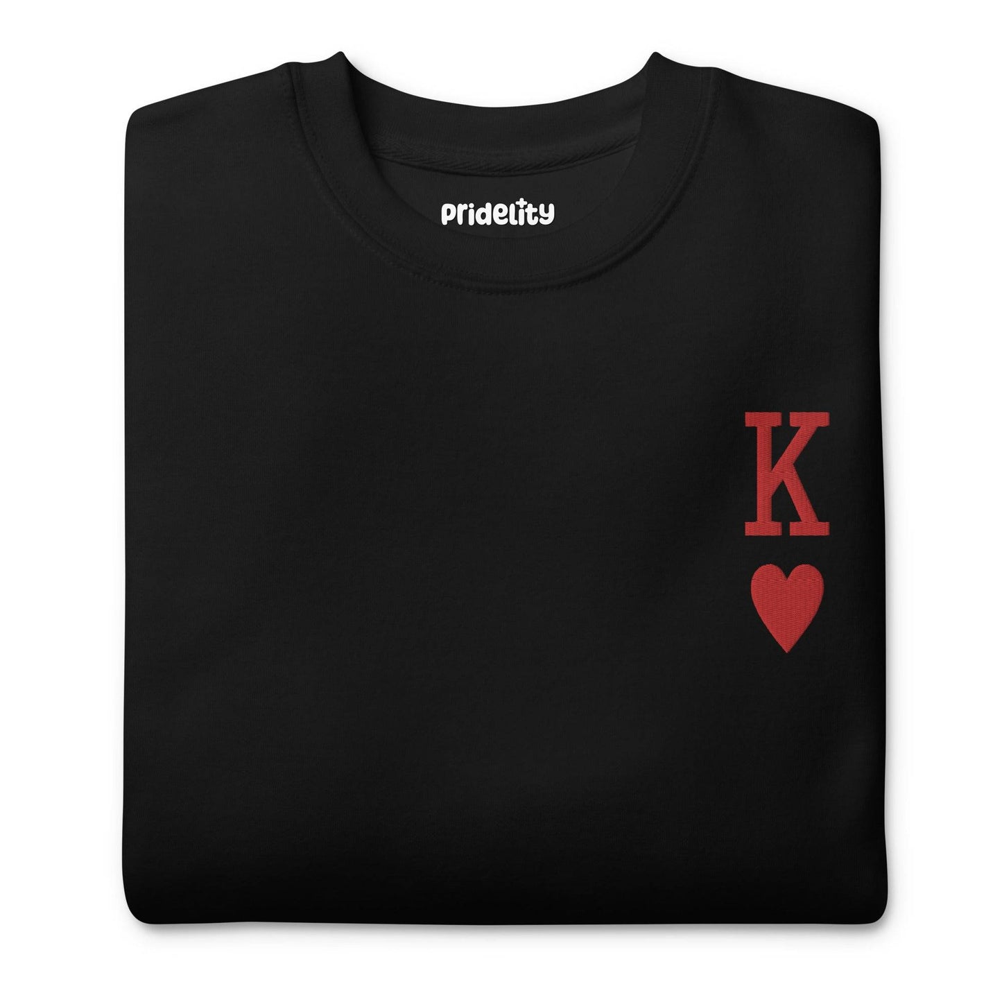 Introducing the King of Hearts Sweatshirt by Pridelity: This black sweatshirt features a distinctive red "K" with a red heart symbol positioned on the upper left side of the chest, making it an ideal companion for your rainbow-colored attire to enhance your stylish ensemble with a vibrant touch.