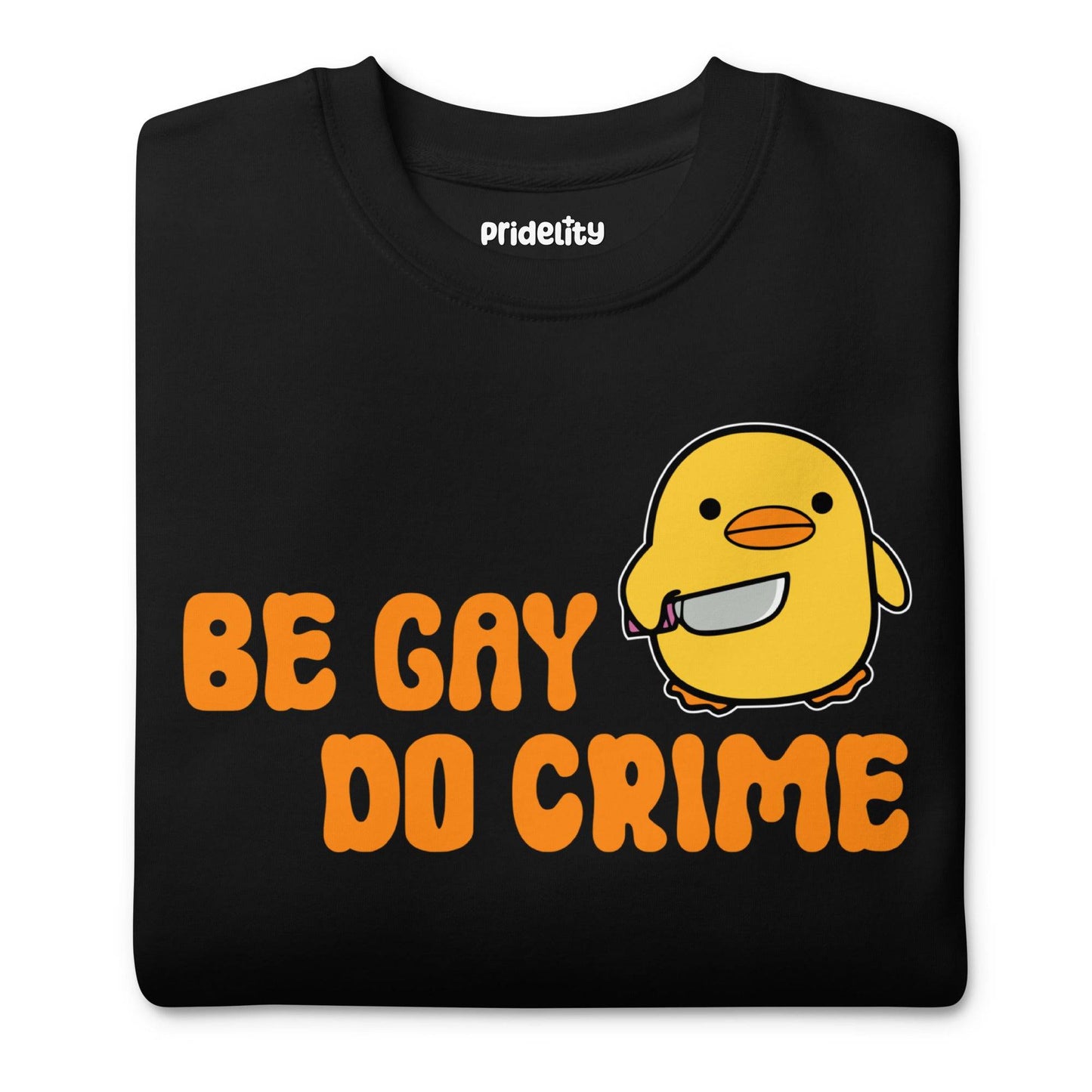 The "Be Gay Do Crime" sweatshirt from Pridelity's Pride Collection is a striking black piece featuring an adorable yellow character holding a knife. The bold orange text proudly states "BE GAY" above and "DO CRIME" below, making it ideal Pride merchandise for those with a rebellious spirit.