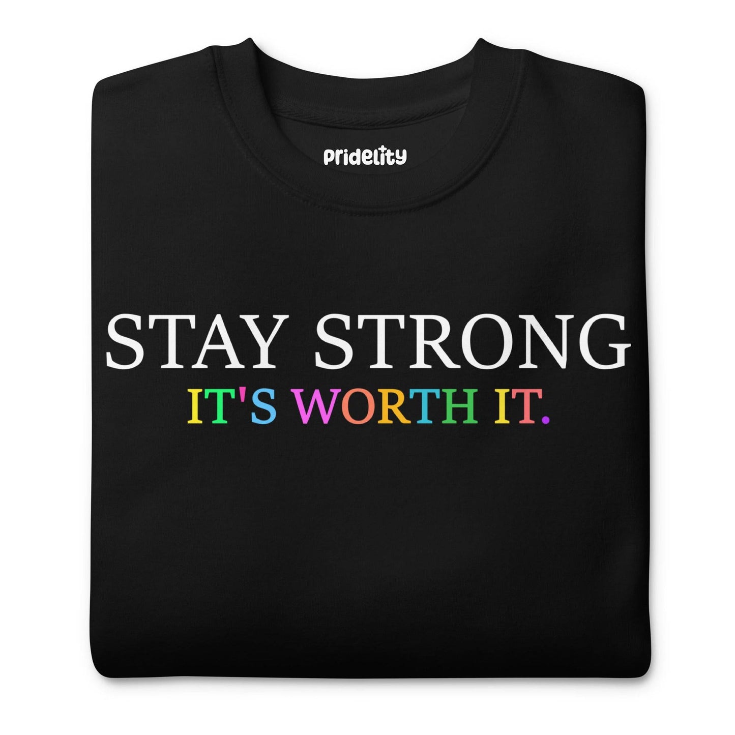 Introducing the "Stay Strong Sweatshirt" by Pridelity from their pride collection. This black sweatshirt features the powerful message "STAY STRONG IT'S WORTH IT." The words "STAY STRONG" stand out in bold white, while "IT'S WORTH IT." radiates in vibrant rainbow colors, making it an ideal choice for celebrating pride.
