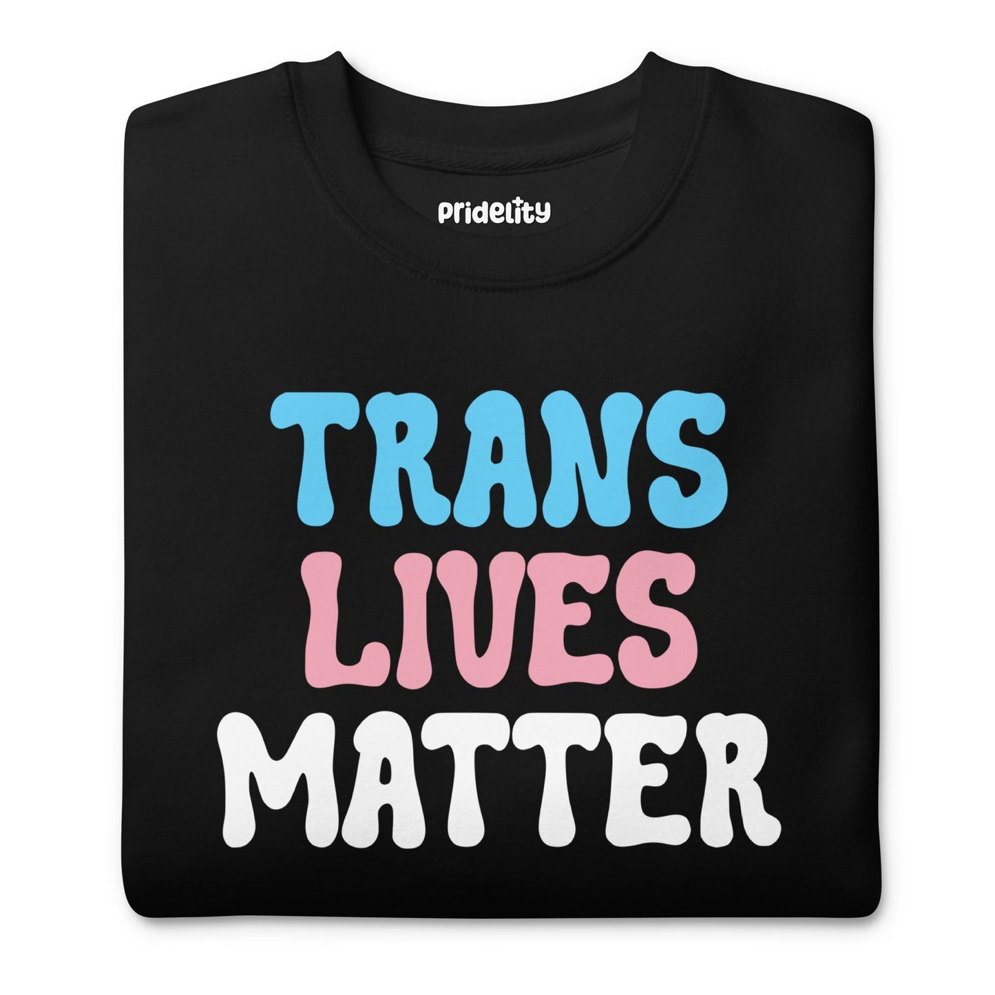 Discover the Pridelity Trans Lives Matter Sweatshirt in black, showcasing an impactful design with "TRANS LIVES MATTER" artfully arranged across three lines. The words are beautifully printed in blue, pink, and white as part of our pride collection to celebrate identity and inclusion.