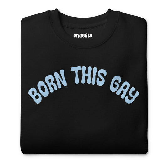 Introducing the **Born This Gay Sweatshirt** by Pridelity, a striking piece from our Pride Merch collection. This black sweatshirt proudly showcases the phrase "BORN THIS GAY" in light blue, elegantly curved across the chest.