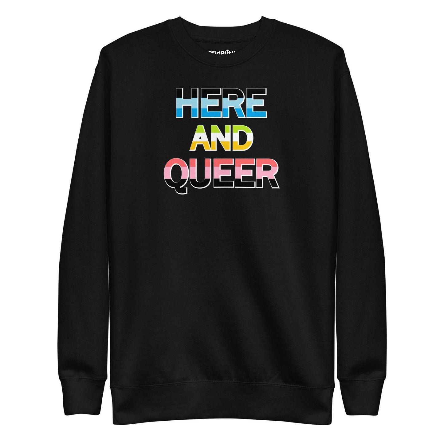 A "Here And Queer" sweatshirt by Pridelity, in a striking Team Royal shade, features a bold print and vibrant rainbow gradient design that elegantly represents LGBTQ+ pride.