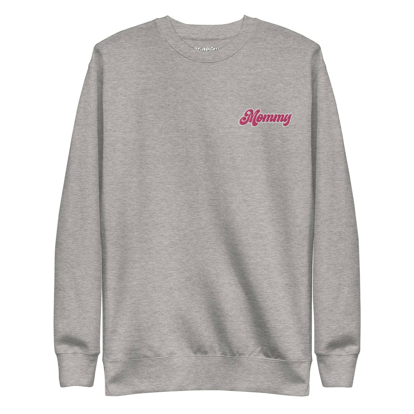 The Mommy Sweatshirt by Pridelity, part of our pride collection, showcases "Mommy" embroidered in pink on the left chest. With its long sleeves and round neckline, this black sweatshirt offers a simple, classic design that's perfect for showing pride in style.