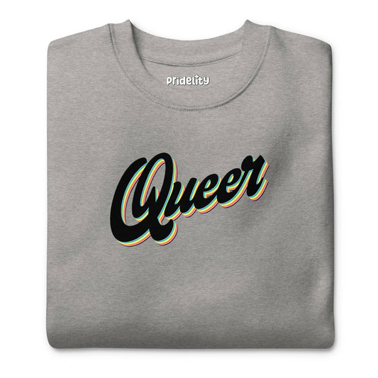 The Carbon Grey Queer Sweatshirt from Pridelity's pride collection showcases the word "Queer" in a stylized, cursive black font with white and yellow outlines across the chest.