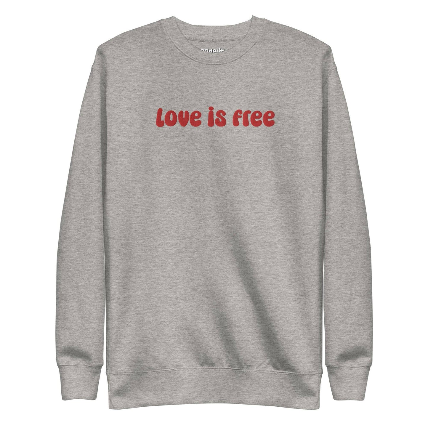The Love Is Free Sweatshirt by Pridelity is a white sweatshirt with "love is free" boldly displayed in red letters across the chest, capturing the vibrant and inclusive essence of rainbow clothes.