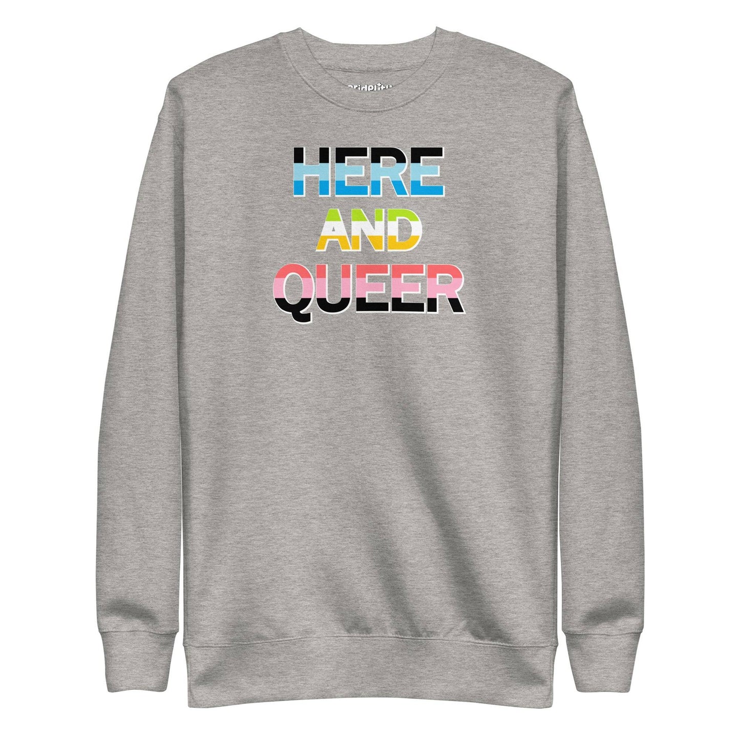 A "Here And Queer" sweatshirt by Pridelity, in a striking Team Royal shade, features a bold print and vibrant rainbow gradient design that elegantly represents LGBTQ+ pride.
